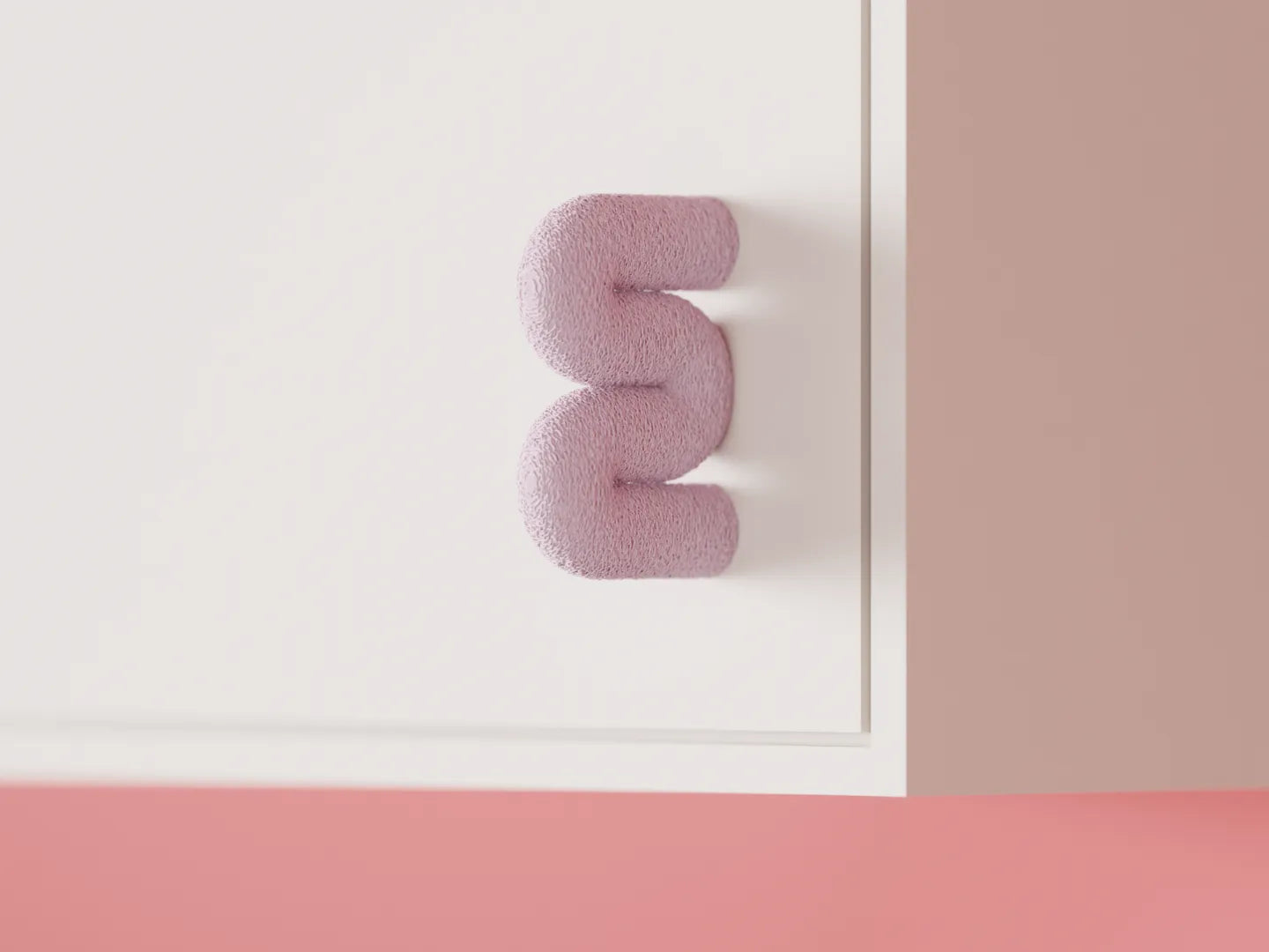 Pink Wibble cabinet door handle shown front-on against a clean white cabinet panel