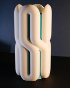 Close product view highlighting the curved channels and contrasting inner vase section.